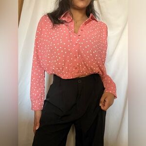 Pink with white polka dot women’s blouse.